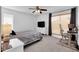 Comfortable bedroom featuring neutral carpet, a ceiling fan, desk, and a large window at 7431 W Mclellan Rd, Glendale, AZ 85303