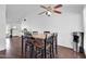 Cozy dining area with vaulted ceilings, contemporary fan, and rustic black wood table at 7431 W Mclellan Rd, Glendale, AZ 85303