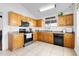 Well-lit kitchen with stainless steel appliances and ample wood cabinet storage space at 7431 W Mclellan Rd, Glendale, AZ 85303