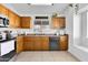 Traditional kitchen features wood cabinetry, stainless appliances, and a sunlit window at 7431 W Mclellan Rd, Glendale, AZ 85303