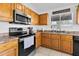Well appointed kitchen featuring wood cabinets, stainless appliances and stone countertops at 7431 W Mclellan Rd, Glendale, AZ 85303