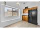 Features cabinetry, a black refrigerator and a window letting natural light in at 7431 W Mclellan Rd, Glendale, AZ 85303