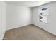 A small, bright bedroom featuring carpet, one window, and neutral decor at 8218 W Illini St, Phoenix, AZ 85043
