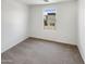 Bedroom with neutral carpet and a window with a view of neighborhood at 8218 W Illini St, Phoenix, AZ 85043