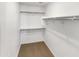 Walk-in closet featuring built-in shelving and ample storage space at 8218 W Illini St, Phoenix, AZ 85043