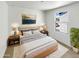 Bright main bedroom features art, a large bed, side tables and plant at 8218 W Illini St, Phoenix, AZ 85043