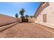 Gravel backyard with views of desert landscaping, walls and trees at 871 W Mesquite St, Gilbert, AZ 85233