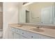 Bathroom featuring double sinks, large mirror, and white cabinets with stone countertops at 871 W Mesquite St, Gilbert, AZ 85233