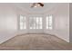 Bright, carpeted bedroom with large windows and a ceiling fan at 871 W Mesquite St, Gilbert, AZ 85233