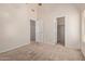 Bedroom with neutral walls, carpet flooring, and open door to a walk-in closet at 871 W Mesquite St, Gilbert, AZ 85233