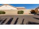 Neighborhood street with a low bush in front of a wall and tall palm trees beyond at 871 W Mesquite St, Gilbert, AZ 85233