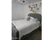 Inviting bedroom with a gray upholstered bed, decorative wall art, and a calming atmosphere at 9205 W Williams St, Tolleson, AZ 85353