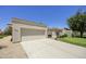 Beige single-story home featuring a large garage, low maintenance yard, and desert landscaping at 10538 E Gold Dust Cir, Scottsdale, AZ 85258