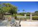 Lush backyard with manicured lawn, desert landscaping, and mature trees offers serene views of the common areas at 10538 E Gold Dust Cir, Scottsdale, AZ 85258