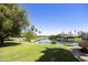 Beautiful backyard area with lush green grass and a serene view of the waterfront community at 10538 E Gold Dust Cir, Scottsdale, AZ 85258
