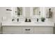 Bright bathroom featuring double sinks with modern black hardware and quartz countertops at 10538 E Gold Dust Cir, Scottsdale, AZ 85258