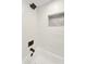 Close-up of shower and tub combo, with a decorative shelf and sleek black hardware at 10538 E Gold Dust Cir, Scottsdale, AZ 85258