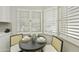 Charming breakfast nook with a round table, seating for two, and natural light from shuttered windows at 10538 E Gold Dust Cir, Scottsdale, AZ 85258