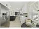 Bright kitchen with stainless steel fridge, a dine-in table, and an open layout to the living space at 10538 E Gold Dust Cir, Scottsdale, AZ 85258