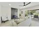 Bright living room with modern fireplace, ceiling fan, and sliding glass doors to outdoor living space at 10538 E Gold Dust Cir, Scottsdale, AZ 85258