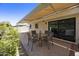 Covered patio with neutral chair seating around a glass table, perfect for outdoor relaxation at 10538 E Gold Dust Cir, Scottsdale, AZ 85258