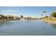 Scenic view of a waterfront community featuring a pond with a fountain and lush landscaping at 10538 E Gold Dust Cir, Scottsdale, AZ 85258