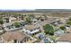 Expansive aerial view of a residential neighborhood featuring homes with pools and desert landscapes against a mountain backdrop at 11521 E Quintana Ave, Mesa, AZ 85212