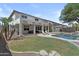 Expansive backyard featuring a refreshing pool, covered patio with grill, and lush landscaping at 11521 E Quintana Ave, Mesa, AZ 85212