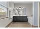 Bright bathroom with double sinks, sleek vanity, soaking tub, and updated fixtures at 11521 E Quintana Ave, Mesa, AZ 85212