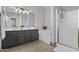 Well-lit bathroom featuring a shower, soaking tub, double sinks, and stylish vanity at 11521 E Quintana Ave, Mesa, AZ 85212