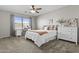 Cozy bedroom with neutral decor, ceiling fan and desk near the window at 11521 E Quintana Ave, Mesa, AZ 85212