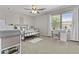 Bright bedroom includes a desk, large window and neutral walls, with a cage in the foreground at 11521 E Quintana Ave, Mesa, AZ 85212