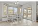 Dining area with built in seating, a white table and sliding glass door for outdoor access at 11521 E Quintana Ave, Mesa, AZ 85212