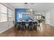 Elegant dining area showcasing a wood table, modern lighting, and a vibrant blue accent wall at 11521 E Quintana Ave, Mesa, AZ 85212