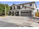 Attractive two-story home showcasing a three-car garage and desert landscaping under a clear sky at 11521 E Quintana Ave, Mesa, AZ 85212