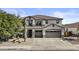 Charming two-story home featuring a spacious three-car garage, desert landscaping, and a beautiful tiled roof at 11521 E Quintana Ave, Mesa, AZ 85212