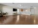 Bright living room features wood floors, a ceiling fan, and media center at 11521 E Quintana Ave, Mesa, AZ 85212