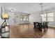 Spacious living room featuring wood floors, a bay window, and a dining area perfect for Gathering gatherings at 11521 E Quintana Ave, Mesa, AZ 85212