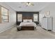 Comfortable main bedroom with stylish decor, soft carpet, and plenty of natural light from the windows at 11521 E Quintana Ave, Mesa, AZ 85212