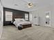 Cozy main bedroom features a dark accent wall, natural wood headboard and neutral decor at 11521 E Quintana Ave, Mesa, AZ 85212