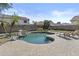 Private backyard pool with rock waterfall feature and lounge chairs for relaxing outdoors at 11521 E Quintana Ave, Mesa, AZ 85212