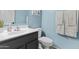 Stylish powder room features a sink, modern vanity, and soothing blue walls for a relaxing experience at 11521 E Quintana Ave, Mesa, AZ 85212