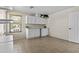 Neutral storage room features cabinets, shelves, tile flooring, counter, and bright light at 11521 E Quintana Ave, Mesa, AZ 85212