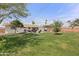 Expansive backyard featuring lush grass, patio area, a built-in grill, and a pergola, perfect for outdoor relaxation at 1321 W 14Th St, Tempe, AZ 85281