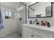 Modern bathroom featuring tiled shower, vanity with a modern sink, and a sleek mirror at 1321 W 14Th St, Tempe, AZ 85281