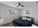 Simple bedroom featuring a ceiling fan, hardwood floors, and natural light from a window at 1321 W 14Th St, Tempe, AZ 85281