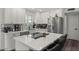 Modern kitchen island featuring stainless steel appliances, white cabinets, and quartz countertops at 1321 W 14Th St, Tempe, AZ 85281