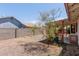 Backyard featuring a covered patio, gravel landscaping, mature trees, and a block wall for privacy at 136 E San Angelo Ave, Gilbert, AZ 85234