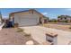 Home featuring a two-car garage and neutral paint, with a low brick wall and gravel in the front at 136 E San Angelo Ave, Gilbert, AZ 85234