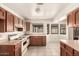 Bright kitchen with tile floors, oak cabinets, white countertops, stainless sink, and a nice view from the windows at 136 E San Angelo Ave, Gilbert, AZ 85234